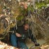 Kevin Owen crawls out of a semi-collapsed tunnel at the Wilson Mine after exploring the length of the tunnel for about 200'. 